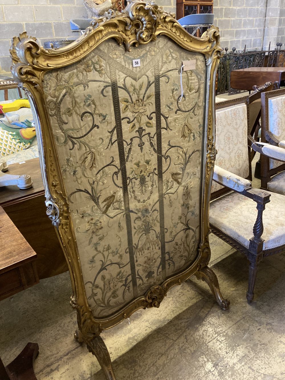 A 19th century Louis XV style giltwood fire screen having embroidered silk panel, width 85cm, height 142cm